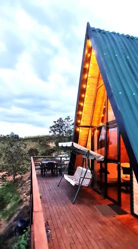 a deck of a house with a table and chairs at Cabaña Starka & Jacuzzi in Marinilla