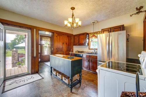 a kitchen with wooden cabinets and a refrigerator at Countryside Home in Wooster with Patio and Fire Pit in Wooster