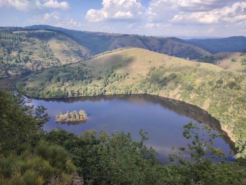 an aerial view of a lake in the mountains at Chambre privée au pays des volcans in Massiac