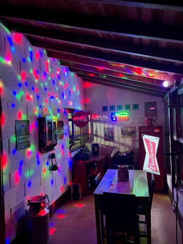 a room with a table and a wall with lights at Hermosa casa finca en Marinilla in Marinilla