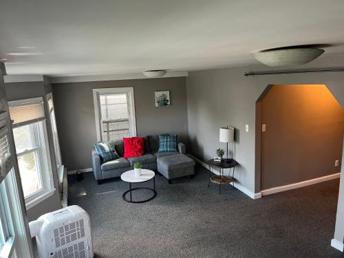 a living room with a couch and a table at Downtown Beverly Apartment 8 Minutes to Salem and has King Beds in Beverly