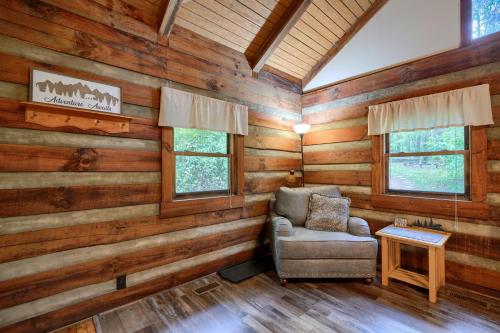 a room with wooden walls and a chair and a table at Cherokee in Logan