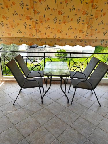 two chairs and a table on a balcony at Makis 2 in Igoumenitsa