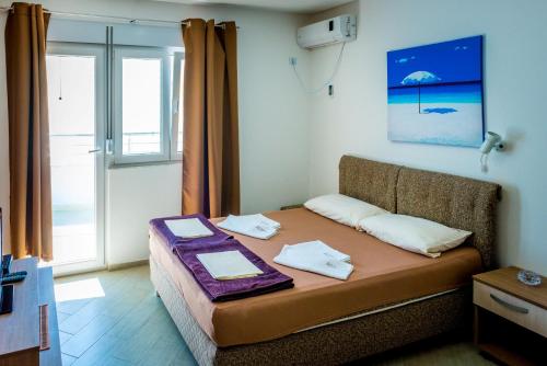 a small bed in a room with a window at Apartmani Barović Bečići in Bečići