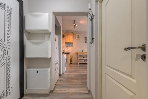 a hallway with a white refrigerator in a kitchen at Sunny Flat-4 People-Delta Mall-Private Parking Space in Wladislawowo