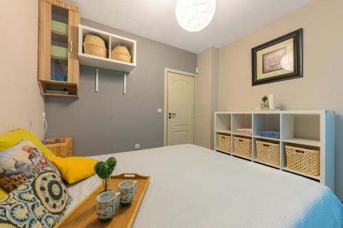 a bedroom with a bed and a couch and shelves at Sunny Flat-4 People-Delta Mall-Private Parking Space in Wladislawowo