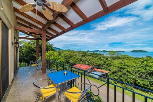a patio with a table and chairs on a balcony at Infinity Pool, Pacific Views & Concierge in Potrero