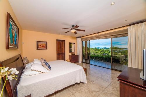 a bedroom with a bed and a large window at Infinity Pool, Pacific Views & Concierge in Potrero
