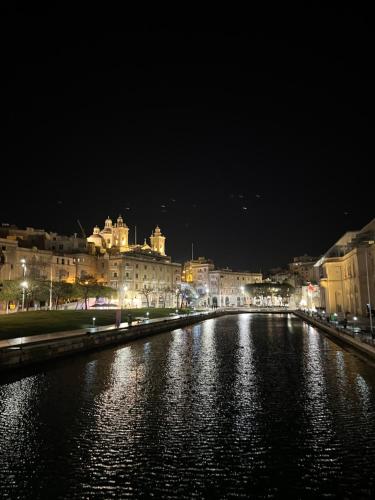 a view of a river at night with buildings at Authentic Maltese Boutique Holiday Home with Rooftop Pool - Moon Townhouse in Cospicua