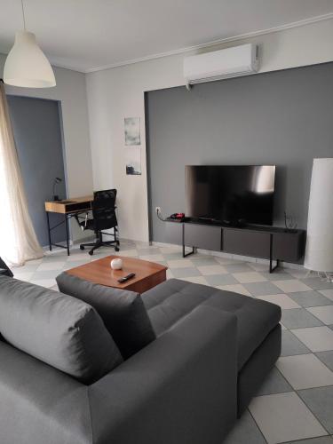 a living room with a couch and a flat screen tv at Makis 2 in Igoumenitsa