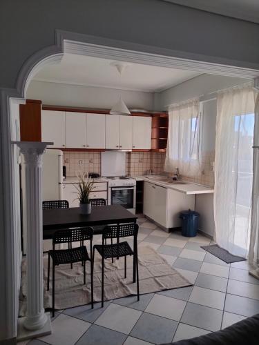 a kitchen with a table and chairs in it at Makis 2 in Igoumenitsa