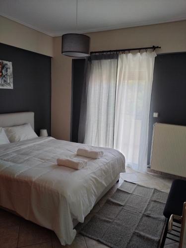 a bedroom with a large bed with two towels on it at Makis 2 in Igoumenitsa