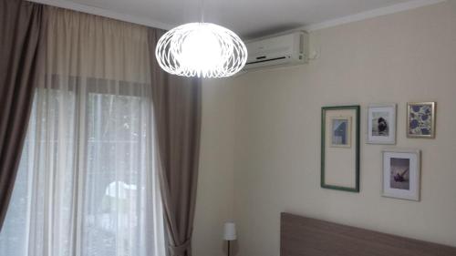 a room with a window and a chandelier at Apartments Fortunella in Budva