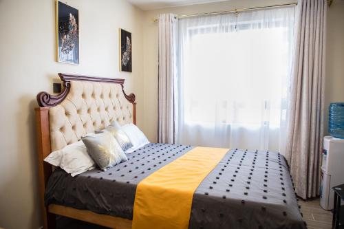 Ένα ή περισσότερα κρεβάτια σε δωμάτιο στο Bela Getaway Homes Deluxe Studio Apartment