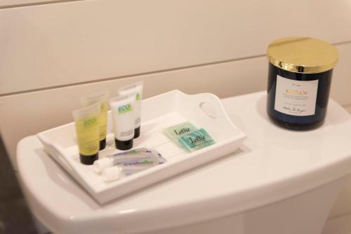 a tray with toothbrushes and cosmetics on a table at The Bluebonnet-Tiny Container Home Country Setting 12 min to Downtown in Bellmead