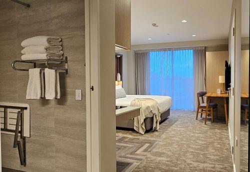 a hotel room with a bed and a desk at Sudima Christchurch City in Christchurch