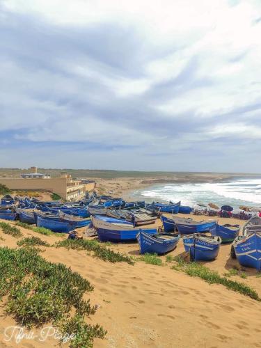 a bunch of blue boats sitting on the beach at Oasis TIFNIT Villa with Pool View No vis A vis in Draïd