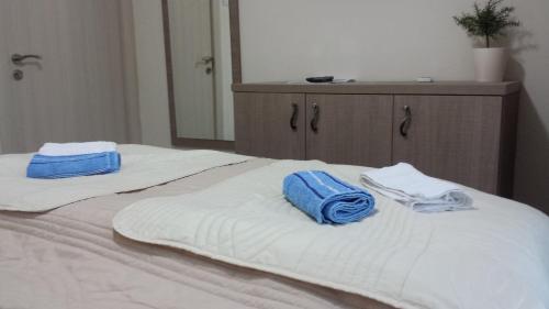 two towels sitting on top of a bed at Apartments Fortunella in Budva