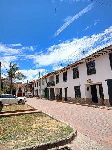a street with a car parked in front of a building at Abi Happy in Villa de Leyva