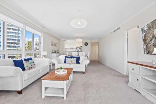 a living room with two white couches and a table at Oscar on Main 2B - Heart of Main Beach Ocean Views - Hosted by Coastal Letting Co. in Gold Coast