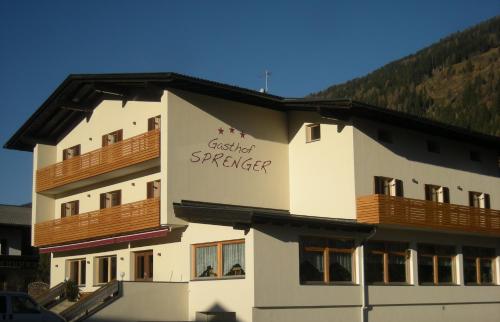 a building with a sign on the side of it at Gasthof Sprenger in Sillian