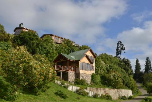 a house on the side of a hill at Cabañas Alcamar in Castro