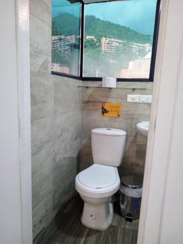 a bathroom with a toilet and a sink at Hostal CasAlé Usaquén in Bogotá