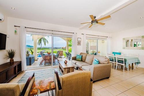 a living room with a couch and a table at Beachfront Hideaway with Pool & Ocean Views in Playa Flamingo