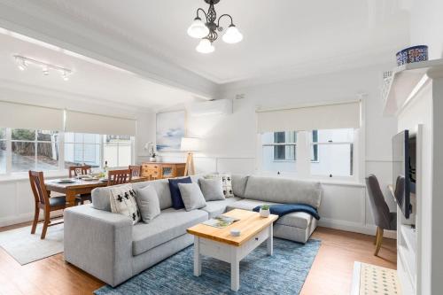 a living room with a couch and a table at Bally Escape - Cottage Serenity in a Scenic Village in Balgownie