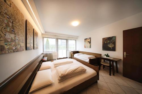 a bedroom with two beds and a desk in it at Holiday Home Falzes in Falzes