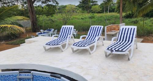 four blue and white chairs sitting on a patio at Cabaña Los Cristales Coveñas by Amauna in Coveñas