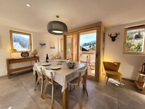 une salle à manger avec une table et des chaises blanches dans l'établissement Résidence Ambrocella - Très bel appartement, lumineux, bel espace de vie MAE-0781, aux Gets