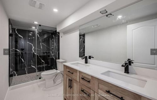 a bathroom with a sink and a toilet and a shower at Rare 3 Bedroom Luxury Close to Lake in Oakville