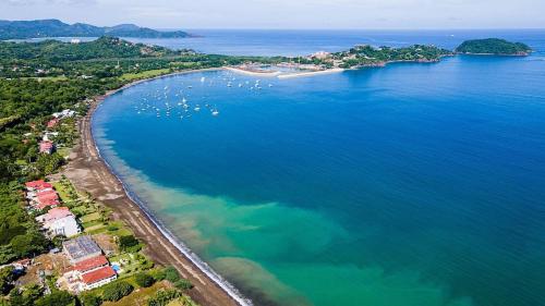 an aerial view of a beach with boats in the water at Beachfront Hideaway with Pool & Ocean Views in Playa Flamingo