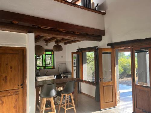 a kitchen with a counter and chairs in a room at Casa en La Comarca in San Javier