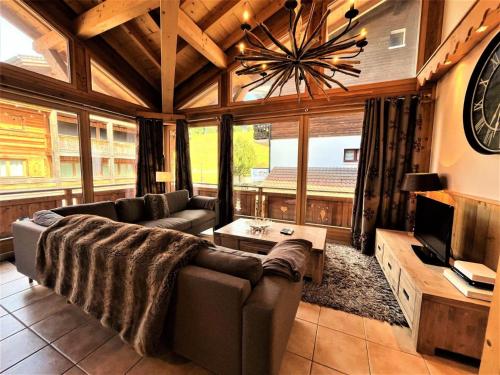 un grand salon avec un canapé et une télévision dans l'établissement Résidence Eden Roc Ii - Beaux volumes au coeur du village MAE-0981, aux Gets