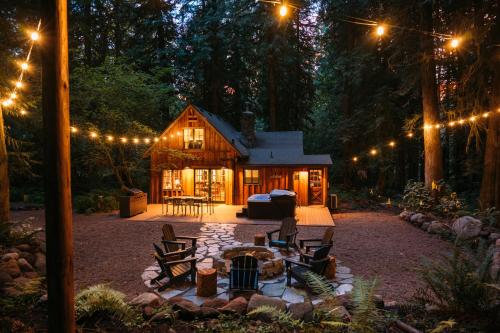 a cabin in the woods at night with lights at Barlow Haus in Mount Hood Village