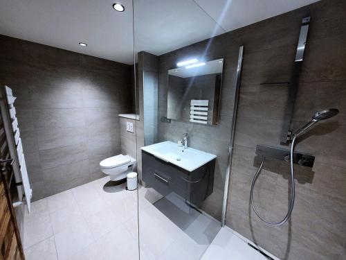 une salle de bain avec une douche, un lavabo et des toilettes dans l'établissement Résidence Le Stella - Appartement haut de gamme 6 personnes au centre MAE-1001, aux Gets