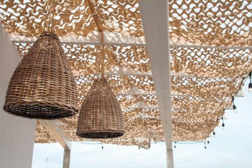 two wicker baskets hanging from a ceiling at Close to Beach Nice Suite in Cabo's Downtown - 5 in Cabo San Lucas