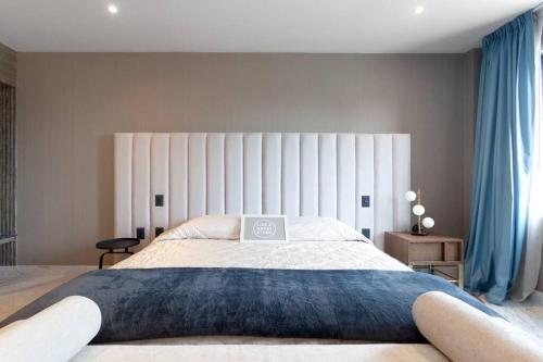 a bedroom with a large bed with a laptop on it at Close to Beach Nice Suite in Cabo's Downtown - 5 in Cabo San Lucas