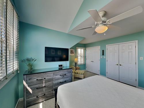 a bedroom with a bed and a ceiling fan at Baylin B #11B in Topsail Beach