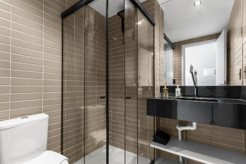 a bathroom with a shower and a toilet and a sink at Alta Garden Housi João Pessoa by Carpediem in João Pessoa