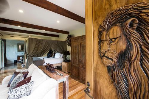 a bedroom with a mural of a lion on the wall at Jamala Wildlife Lodge in Canberra