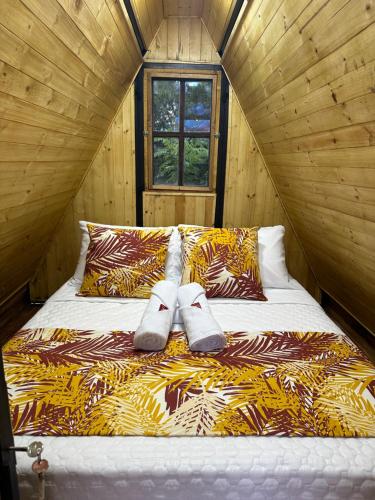 a bedroom with a bed with two towels on it at El Ensueño Ecohostal & Glamping in Mocoa