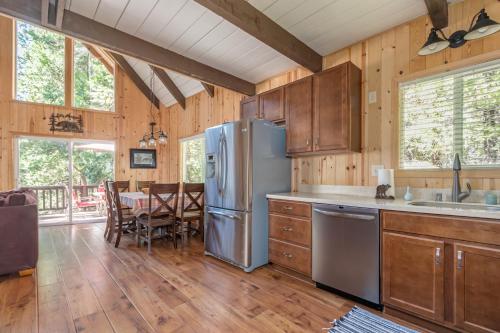 a kitchen with a refrigerator and a dining room at Pops Place in Arnold