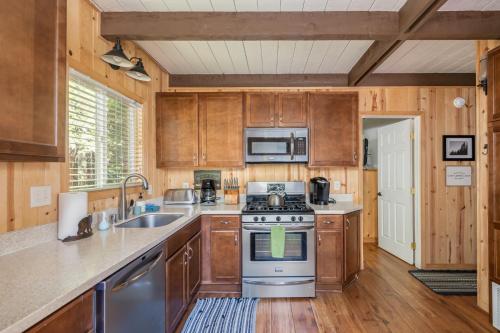 a kitchen with stainless steel appliances and wooden cabinets at Pops Place in Arnold