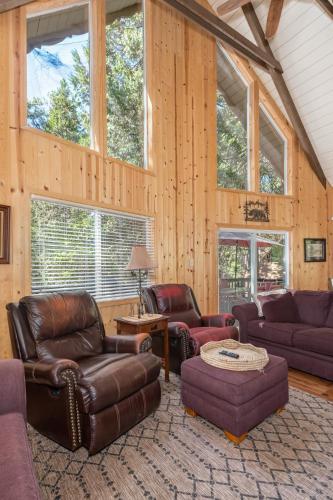 a living room with leather furniture and windows at Pops Place in Arnold