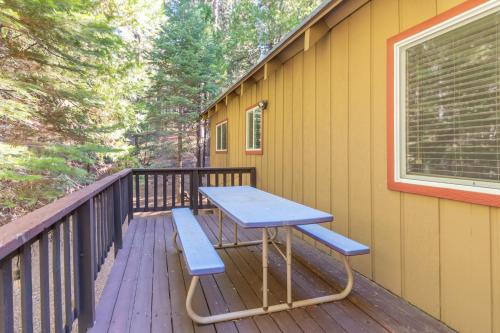 a picnic table and a bench on a deck at Pops Place in Arnold