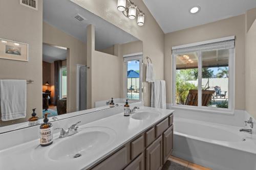 a bathroom with two sinks and a large mirror at Lavish 3br Haven W Private Pool in Mesa