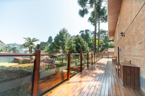 a wooden walkway next to a building at Pousada Santa Felicidade in Campos do Jordão